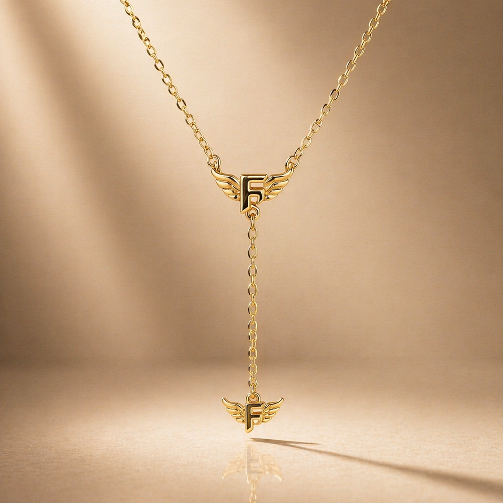 Gold necklace with a unique pendant on a beige background