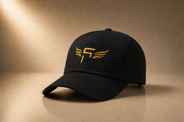 Black cap with gold logo on a brown background