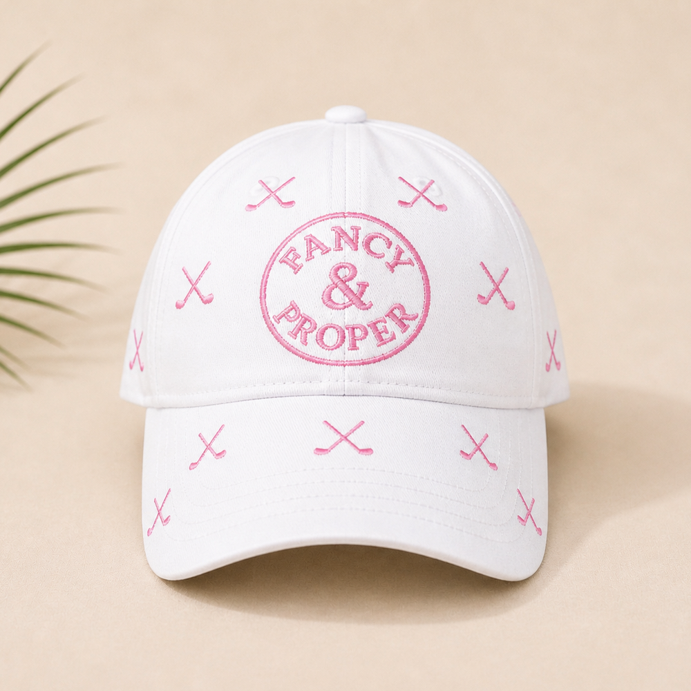 White cap with pink 'Fancy & Proper' logo on a beige background
