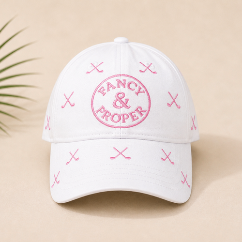 White cap with pink 'Fancy & Proper' logo on a beige background