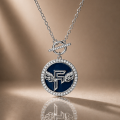 Necklace with a blue pendant featuring a logo on a reflective surface.