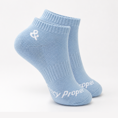Pair of light blue socks with a logo and text on a white background
