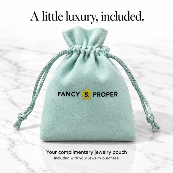Complimentary pale aqua Fancy & Proper Tennis jewelry pouch, standing upright and full, included with this jewelry purchase.