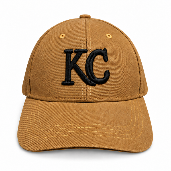 Deeper mustard gold Kansas City cap with soft textured fabric and raised black KC monogram, front view on white