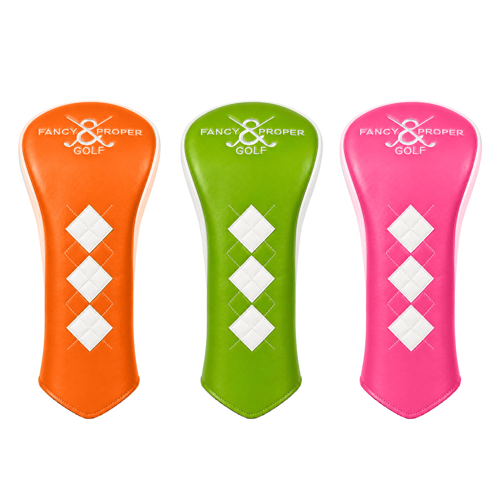 Three golf club head covers in orange, green, and pink with 'Fancy & Proper Golf' branding on a white background.