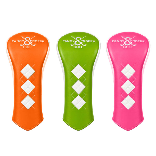 Three golf club head covers in orange, green, and pink with 'Fancy & Proper Golf' branding on a white background.