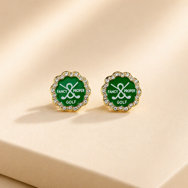 Green and gold earrings with 'Fancy Proper Golf' text on a beige background