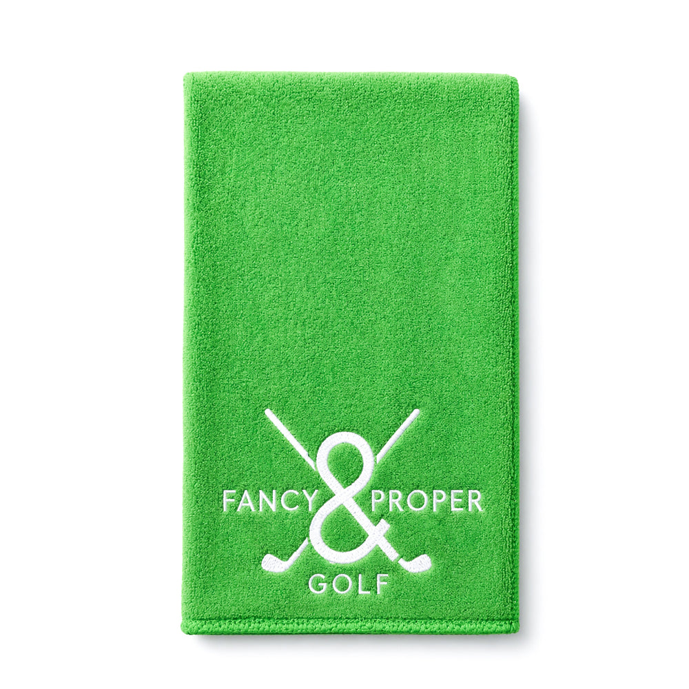 Green golf towel with 'Fancy & Proper Golf' logo on a white background